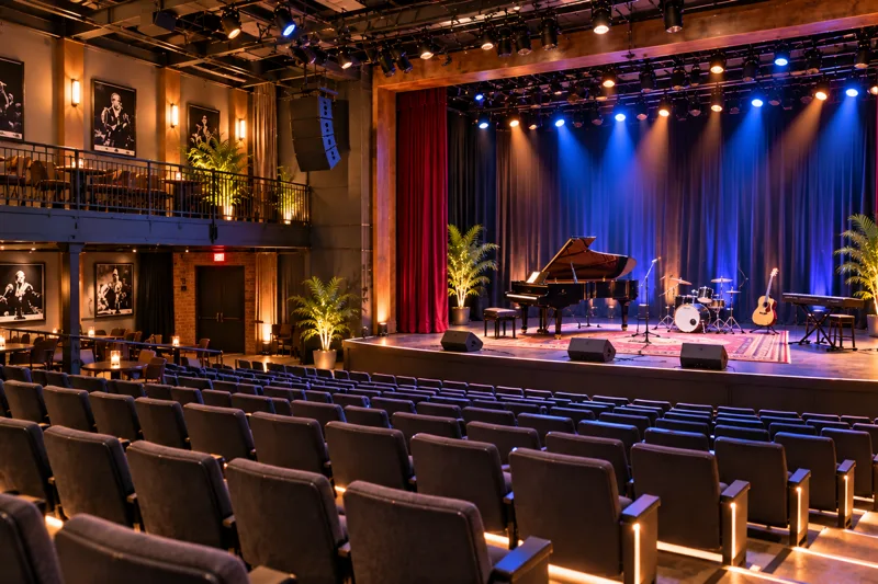 Los Angeles rehearsal and live event space with open floor, stage equipment and performers preparing