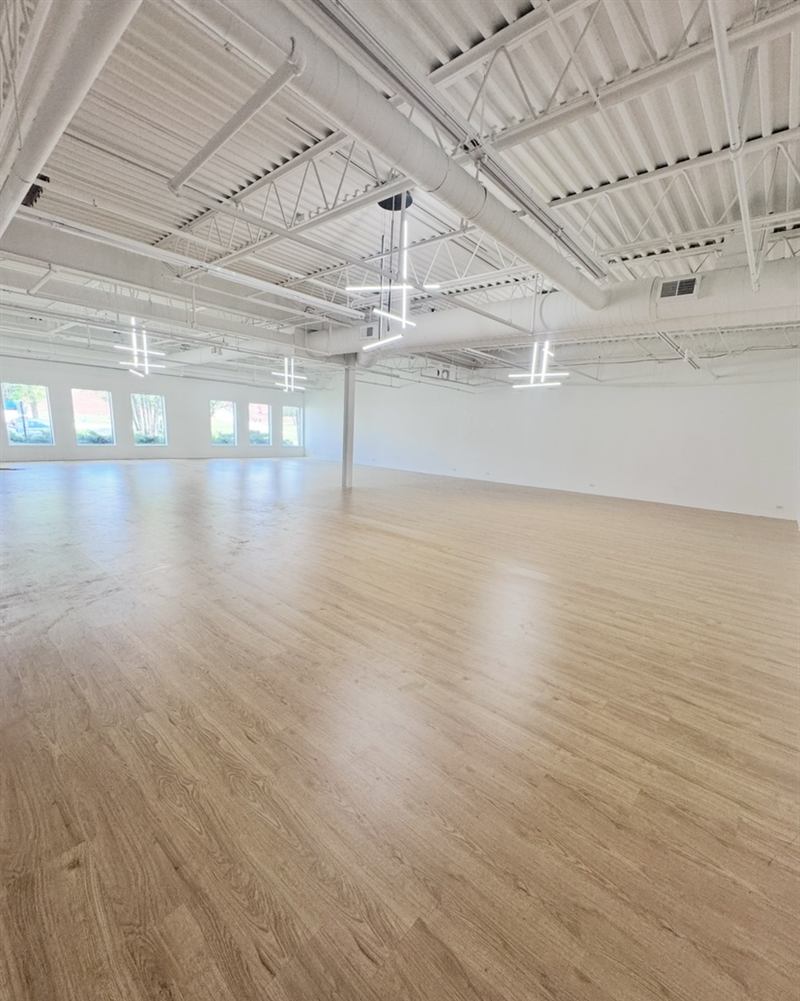 Modern Loft Event Space With High Ceilings Draping and Statement Lighting