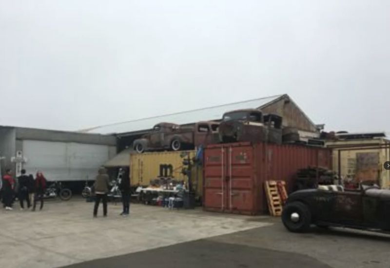 Vintage Industrial Art Workshop with Hot Rods, Motorcycles, and Skylight