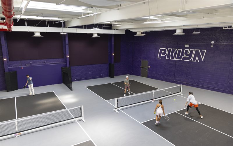 Skylit Indoor Pickleball Club With Bar and Social Lounge
