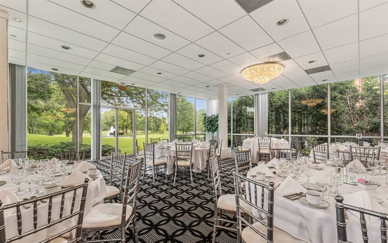 Golf Club Ballroom with Glass Walls, Fireplace and Garden Views