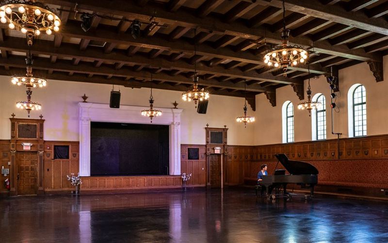 Elegant Performance Hall With Arched Windows and Grand Piano