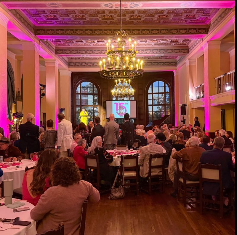 Vaulted-ceiling Rehearsal and Workshop Hall with Piano, Kitchen Prep Area, and Natural Light