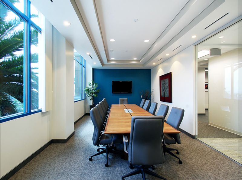Bright Conference Room with Large Screen and Whiteboard